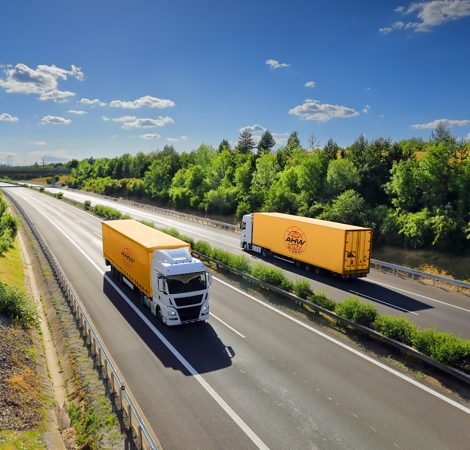 Cargo,Truck,Driving,Through,Landscape,At,Sunset